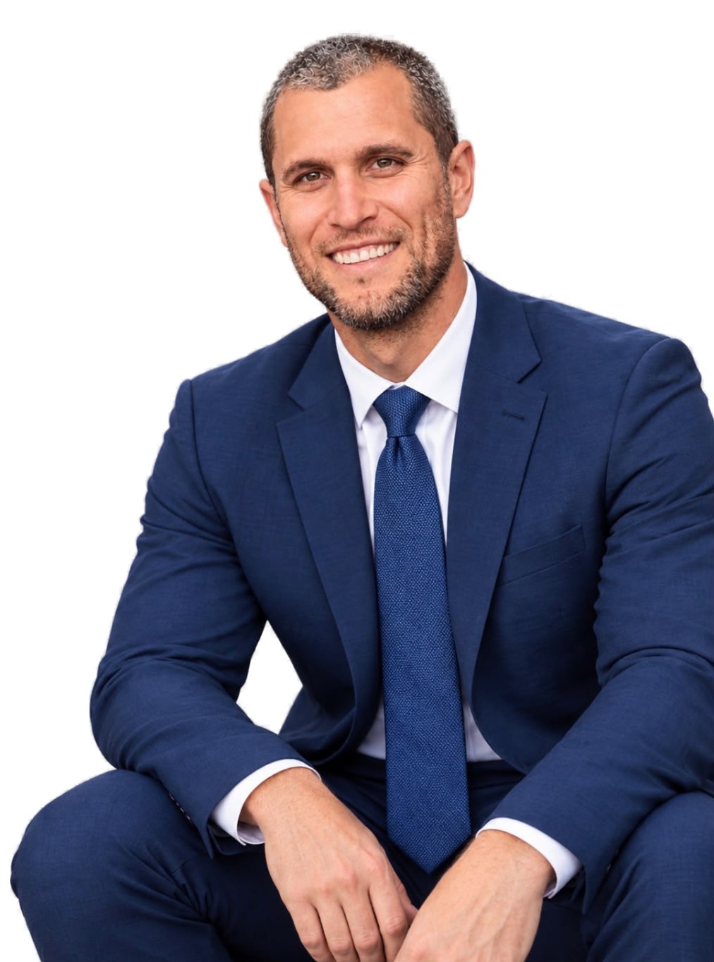 Keke Lyles, human performance consultant, in a navy suit and blue tie